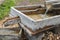 Stream of fresh Alpine water flowing through handmade wooden chute spout