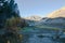 Stream moving through mountains with grassy shoreline