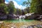 Stream with rocks in a natural scenic landscape