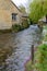 A stream running past houses through Bourton on the water