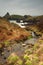 Stream runs down to the rugged coastline, Kynance Cove, Cornwall.