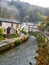 Stream runs between the pretty village cottages of Castleton, Derbyshire Peak district.