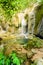 Stream rushing through cascade to emerald pond at Thac Voi waterfall, Thanh Hoa