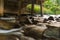 Stream under the domestic bridge in the forest of Thailand