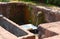 Stream of Water coming out of Cow Mouth Gomukh in an Ancient Hindu Temple, Karhateshwar Shiva Temple