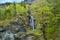 A stream and waterfall in the forest of Swiss Alps. Reichenbach Waterfall