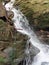 A stream with a white waterfall on the roch in the natural protected landscape area of the ReÅ¡ov waterfalls