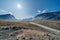 Stream winds through wild arctic landscape in Akshayuk Pass, Baffin Island, Canada. Moss valley floor and dramatic