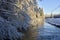 Stream in the winter with frosty birch in foreground