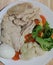 Streamed organic chicken breast serving with sliced medium boiled egg and various vegetables corn carrot peas Broccoli