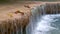 Streaming water of tropical waterfall and colorful leaves. Kanchanaburi, Thailand