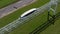 Streamlined unibus drives on overpass railway on sunny day