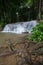 Streams of water pouring down onto limestone rocks under shades of trees at Kroeng Krawia Waterfall,Khao Laem National Park,Sangkh