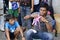 Street actor with a group of people on the townl square demonstrates tricks with paper