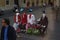 Street actors dressed as sitting figures with no heads and floating Fedoras, work for tips on a street corner in Rome