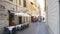 Street alley scene with outdoor cafe in in old European city