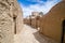 Street in ancient muddy village Kharanaq in Iran