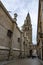 Street arch of palace with the tower of gothic cathedral of Toledo