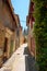 Street in Arles with old cute houses and church. Provence region