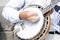 Street artist playing banjo musician detail of hands