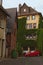 The street with a backyard of a big residential building. Small red car parked in the corner of backyard. Historic part of Wetzlar