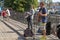 Street band of two guys with drum and guitar gives a concert on the Honey bridge across the river