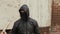 Street bandit in black mask and hood holds baseball bat in criminal district