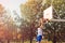 Street basketball player performing power slum dunk