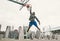 Street basketball player performing power slum dunk