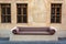 Street bench covered with ornate seat cushion in Doha