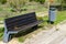 Street bench next to the modern garbage bin