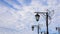 Street beutiful vintage lamps aligned with beautiful blue sky with white clouds on background. Horizontal banner with