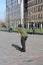 Street boy raised in the modern metropolis of Rotterdam in the Netherlands. Young man practices his skateboard in a square among