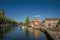 Street and bridge over the canal, moored boats and brick houses at sunset in Weesp.