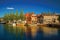 Street and bridge over the canal, moored boats and brick houses at sunset in Weesp.