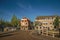 Street and bridge over the canal, moored boats and brick houses at sunset in Weesp.