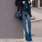 Street, bright style. A young girl in a blue fur coat with a handbag in heels. Details
