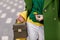 Street, bright style. A young girl in white trousers, warm greens polto. Yellow scarf. Green jacket. A brown handbag