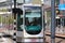 Street cars Trams of the RET in Rotterdam on the streets type Citadis in the Netherlands with buildings and scyscraper