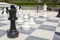 Street chessboard with chessmen and brown chairs
