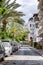 Street in the city with palm trees along the road. Sunny resort town.