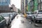 Street in a city without people with parked cars in rainy weather. Rain on the road. Rain and cars. Background of parked cars on a