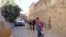 Street cleaning worker with his donkey sweeping roads of old town Mardin, Turkey