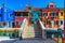 Street with colorful buildings, canal and bridge in Burano island, Venice, Italy.