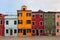 Street of colourful houses in burano venice in summer