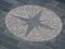 Street compass in paving cobblestones, Italy. Eight pointed star.