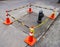 Street cones with connecting striped orange white plastic bars