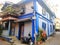 Street corner old fashioned house in the suburbs of Bandra blue Mumbai with green trees