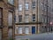 Street corner view of closed and boarded up old abandoned industrial and office buildings in the little germany area of bradford