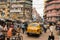 Street crowded with pedestrians, cars, bicycles in the Kolkata downtown.